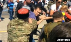 Russian opposition leader Aleksei Navalny (in purple shirt) and his supporters are attacked by Cossacks in Anapa in 2016.