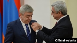 Armenia -- President Serzh Sarkisian awards a medal to his brother Levon, March 22, 2016.