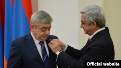 Armenia -- President Serzh Sarkisian (R) awards a medal to his brother Levon Sarkisian, 22 March, 2016