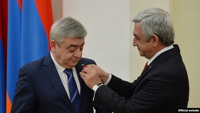 Armenia -- President Serzh Sarkisian (R) awards a medal to his brother Levon, March 22, 2016.