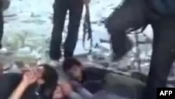 A video dated November 1 uploaded on YouTube appears to show Syrian government forces lying on the ground and being kicked before being shot by rebel fighters at the Hamisho checkpoint near Saraqeb.