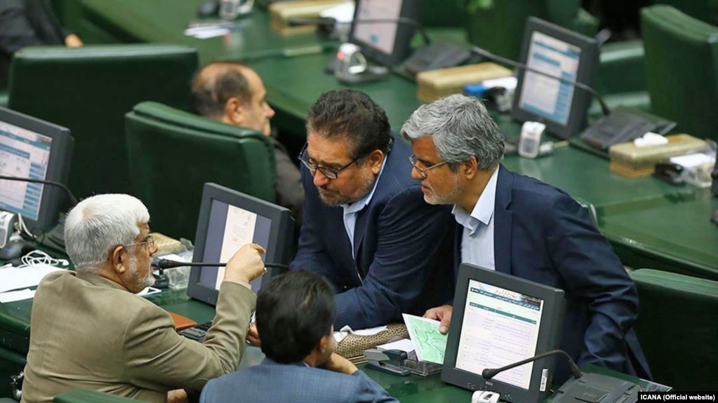 Members of the Iranian parliament talking during a session in August 2017. Mahmoud Sadeghi is seen on the right.