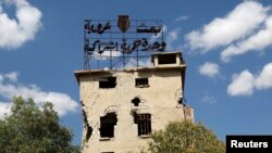 Алеппо в июне 2013 года. Плакат на здании гласит: "БААС, арабизм, единство, свобода, социализм"