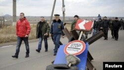 Russia-backed separatists lead Ukrainian prisoners of war during a prisoner exchange at a checkpoint west of Donetsk on November 15, 2015.