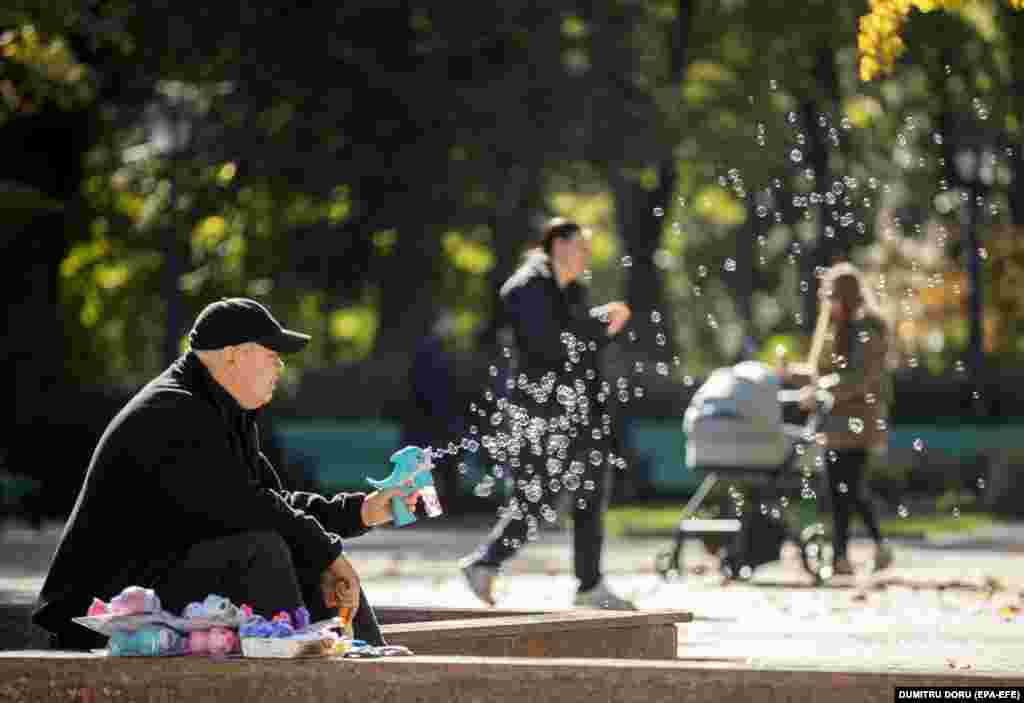 A man sells bubble-making toys on a sunny day in a park in the Moldovan capital, Chisinau.