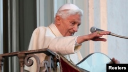 Pope Benedict XVI waves as he appears for the last time at the balcony of his summer residence in Castel Gandolfo