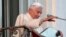 Pope Benedict XVI waves as he appears for the last time at the balcony of his summer residence in Castel Gandolfo