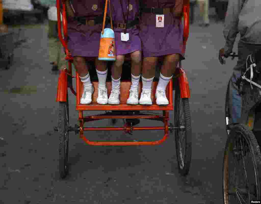 Girls travel to school in a rickshaw in the old quarters of Delhi, India. (Reuters/Ahmad Masood)