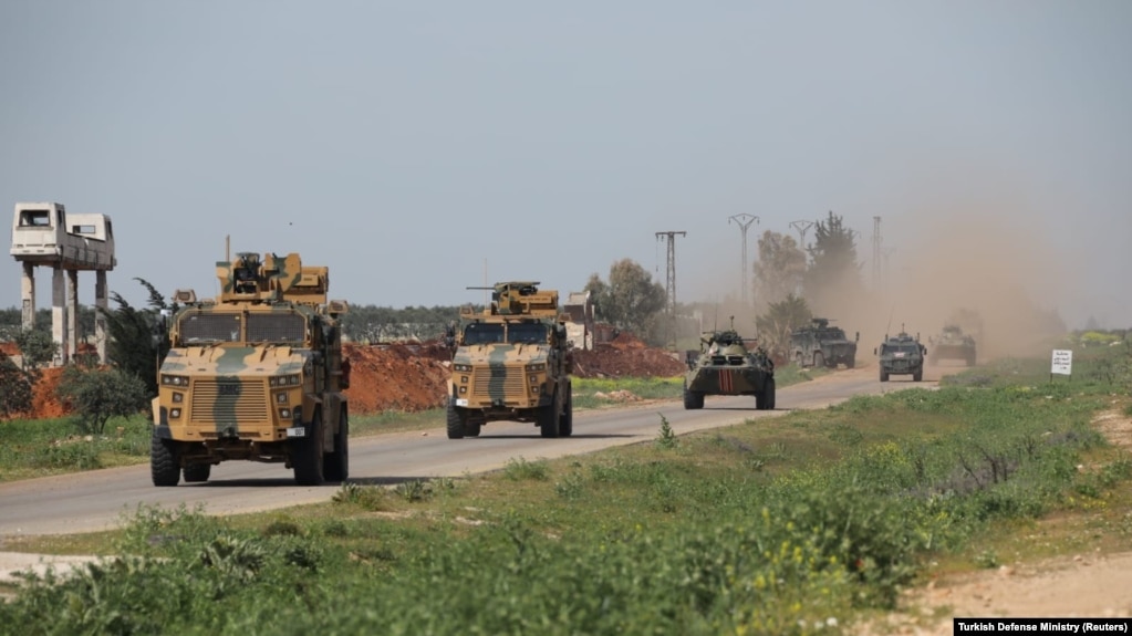 Turkish and Russian military vehicles take part in a joint patrol in the Idlib province, April 15, 2020.