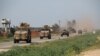 Turkish and Russian military vehicles take part in a joint patrol in the Idlib Province. 