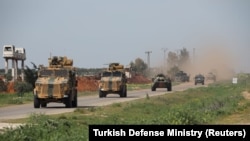 Turkish and Russian military vehicles take part in a joint patrol in the Idlib Province. 