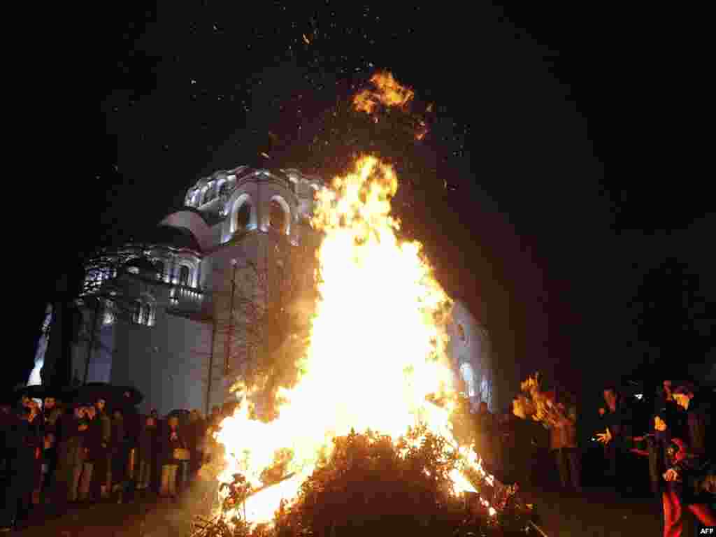 The dried oak branches are later burned in a ceremony like this one at the Saint Sava Cathedral in Belgrade.