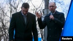 Opposition leaders Arseniy Yatsenyuk (right) and Vitali Klitschko speak during a rally in support of EU integration in front of the Cabinet of Ministers building in Kyiv last week