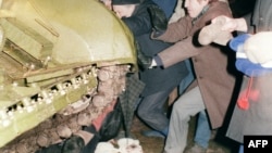 A group of Lithuanians attempt to stop a Soviet Red Army tank from crushing a fellow protester during the assault on the Lithuanian Radio and Television station in Vilnius in January 1991.