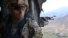 Американский офицер смотрит на землю Афганистана с борта вертолета "Блэк хок"
