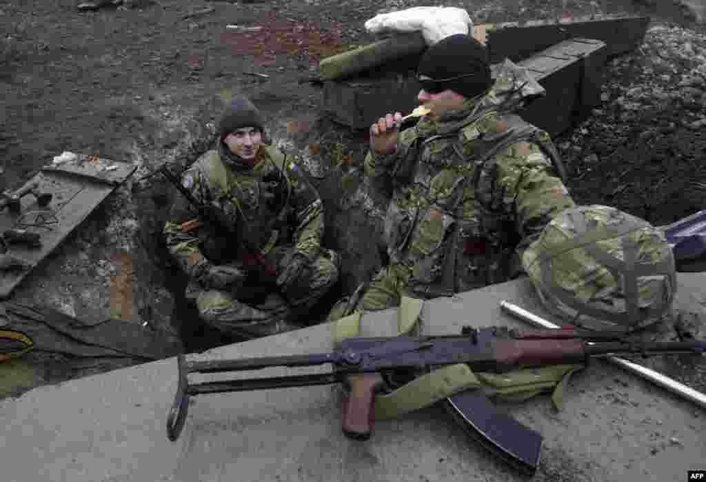 Ukrainian servicemen stand guard at the besieged airport in the eastern city of Donetsk. Ukrainian President Petro Poroshenko said a "real" cease-fire was in place in Ukraine for the first time since the conflict in the east erupted seven months ago. (AFP/Anatoliy Stepanov)