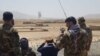 Afghan military officers watch clashes in Takhar in August. 