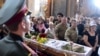 People take part in the funeral ceremony for opera singer Vasyl Slipak, who died fighting Russia-backed forces in eastern Ukraine, in St. Paul and Peter Cathedral in the western city of Lviv on July 1. (AFP/Yuriy Dyachyshyn)