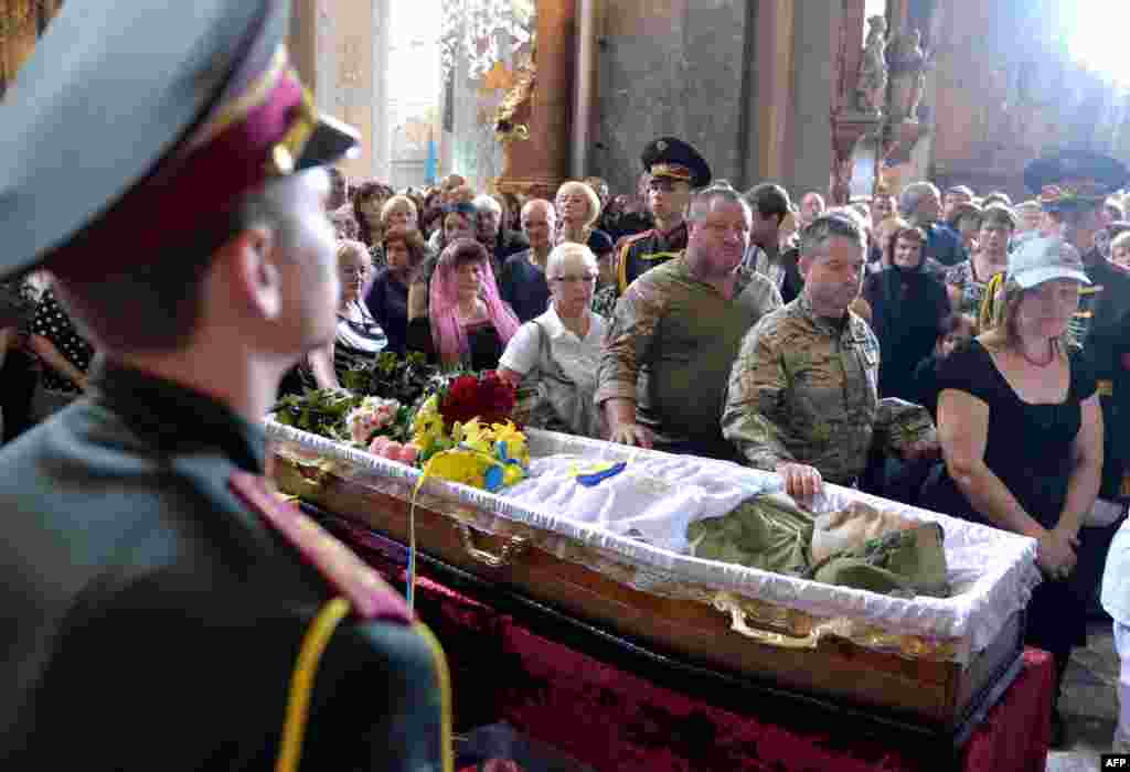 People take part in the funeral ceremony for opera singer Vasyl Slipak, who died fighting Russia-backed forces in eastern Ukraine, in St. Paul and Peter Cathedral in the western city of Lviv on July 1. (AFP/Yuriy Dyachyshyn)