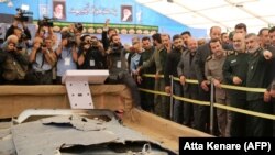 Iranian Revolutionary Guards commander Major General Hossein Salami and General Amirali Hajizadeh head of IRGC aerospace division (on the right), are among those looking at debris from what Iran presented as a downed US drone. September 21, 2019