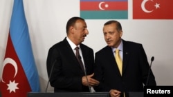 Turkey -- Azerbaijan's President Ilham Aliyev (L) chats with Turkey's Prime Minister Tayyip Erdogan during a news conference following a signing ceremony in Istanbul, 26Jun2012 