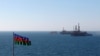 AZERBAIJAN -- Flag and oil platform in the Caspian Sea. January 22, 2013. 