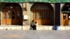 Two young people chat outside the Imamzade Ismayil Mausoleum in Qazvin, Iran. (file photo)