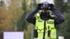 An Estonian police officer looks on near Rapla