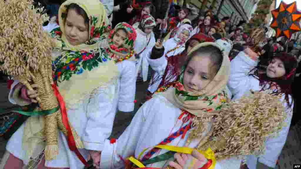 Children in traditional costumes parade during Orthodox Christmas eve celebrations in Lviv, Ukraine. AFP PHOTO/YURIY DYACHYSHYN
