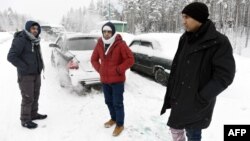 Asylum seekers from Afghanistan and Pakistan wait for permission to cross the Arctic border into Finland in January.