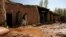A disabled man walks inside his damaged home after heavy rain in the Zari district of Balkh Province, in northern Afghanistan on March 25.