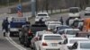 Armenia -- Police officers enforcing a coronavirus lockdown check cars leaving Yerevan, April 1, 2020.