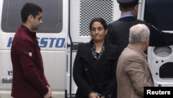 Mohammad Shafia, his wife Tooba Mohammad Yahya, and their son Hamed (right to left) arrive at the Kingston, Ontario, courthouse on January 26.