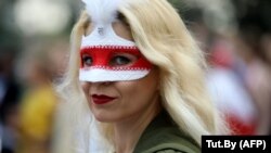 A Belarusian opposition supporter wears a mask during a rally to protest the disputed results of the August 9 presidential election in Minsk on September 6.