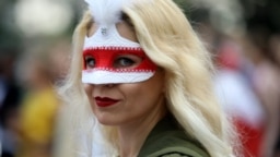 A Belarusian opposition supporter wears a mask during a rally to protest the disputed results of the August 9 presidential election in Minsk on September 6.