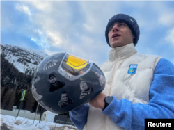 Heraskevych holds his helmet with images of compatriots killed during the war in Ukraine, at the Milano Cortina Gamesin in Cortina D'Ampezzo, Italy, on February 9.