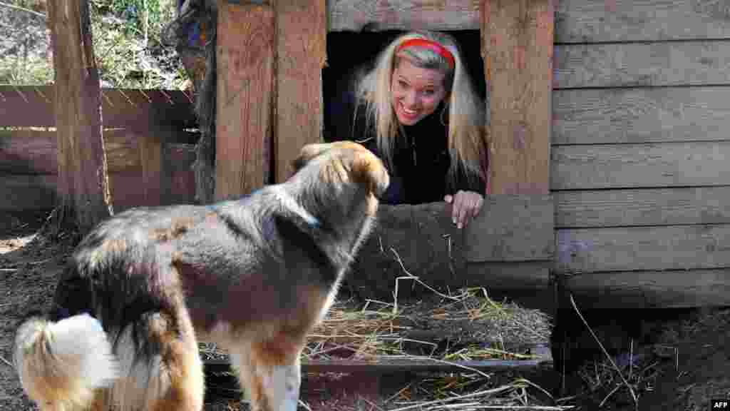 German Princess Maja von Hohenzollern looks out from a dog kennel during her visit on April 11 to the Sirius shelter outside the Ukrainian capital, Kyiv, where some 1,600 stray dogs and cats are housed. (AFP/Sergei Supinsky)