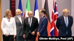 From left, European Union foreign policy chief Federica Mogherini, Iranian Foreign Minister Javad Zarif, French Foreign Minister Jean-Yves Le Drian, German Foreign Minister Heiko Maas and British Foreign Secretary Boris Johnson pose for a photo in Brussels on May 5, 2018. 