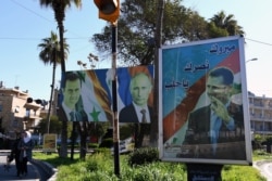 Уличные портреты Башара Асада, Владимира Путина и лидера "Хезболлы" шейха Хасана Насраллы в Алеппо