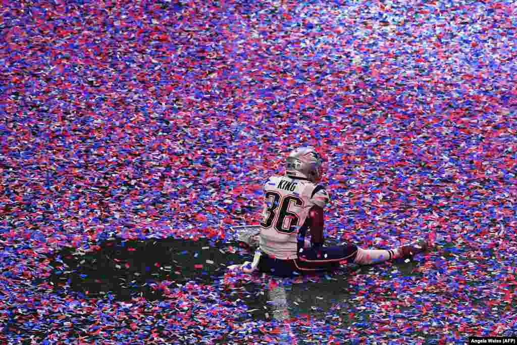 American football player Brandon King of the New England Patriots sits in confetti on the playing field after his team won the Super Bowl against the Los Angeles Rams in Atlanta, Georgia, on February 3. (AFP/Angela Weiss)