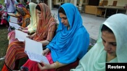 Teachers recite verses from the Koran as they pray for the speedy recovery of schoolgirl Malala Yousafzai at a school in Peshawar on October 12.