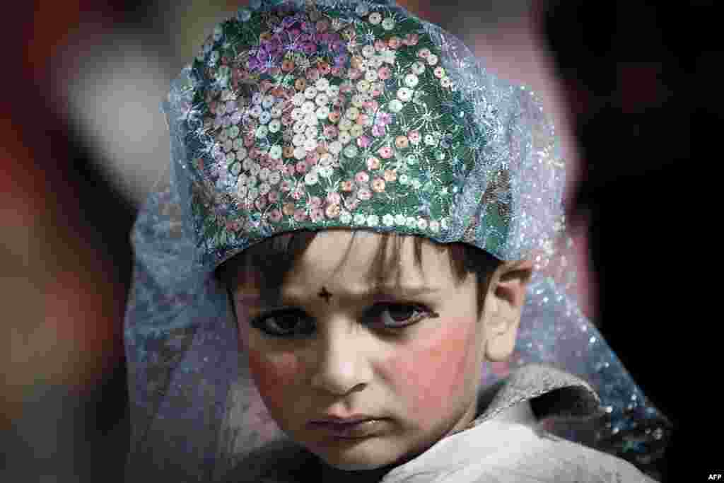 A girl is dressed as an angel during a Ta&#39;zieh performance.