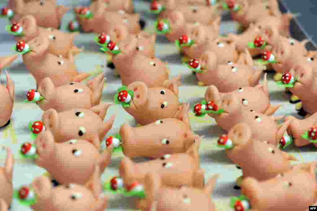 A tray with marzipan pigs is pictured in Villingen-Schwenningen in southern Germany. Marzipan figures are often used for decorating the New Year&#39;s Eve menu in Germany. (AFP/Patrick Seeger)