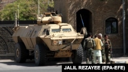 Afghan security officials patrol in Herat on August 7 after regaining control of parts the city following an intense battle with Taliban militants.