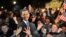 People celebrate in front of the White House in Washington after television networks announced the reelection of U.S. President Barack Obama.