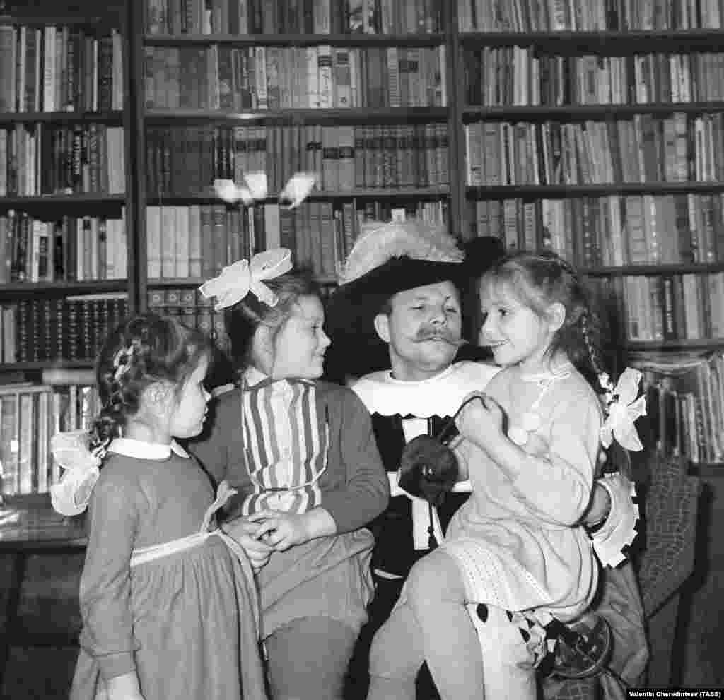 Gagarin, dressed as a musketeer, is pictured with his youngest daughter, Galina; Ira Komarova, the daughter of cosmonaut Vladimir Komarov; and his older daughter, Yelena, on December 31, 1965.&nbsp;