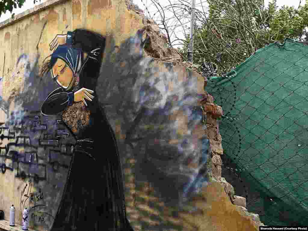 شمسیه&nbsp;حسنی، نقاش افغان،&nbsp;روی دیواری در کابل، زنی را به تصویر کشیده که&nbsp;از خودش دفاع می کند.