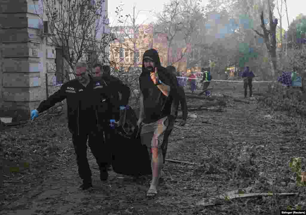 The body of a person discovered under rubble in Dnipro is carried away following a wave of strikes that hit the eastern city on June 2.