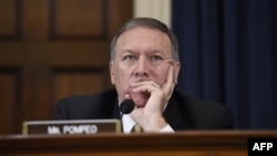 U.S. Representative Mike Pompeo listens as former U.S. Secretary of State and Democratic presidential hopeful Hillary Clinton testifies before the House Select Committee on Benghazi in Washington, D.C., in October 2015.