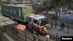 Security officials stand near a truck carrying supplies at the Afghan-Pakistani border. (file photo)